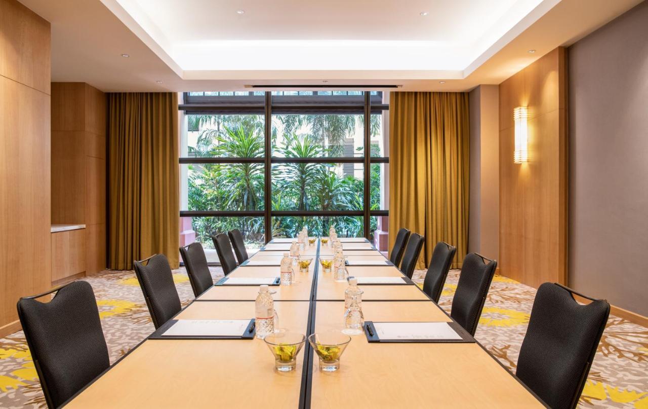 Paradox Singapore Merchant Court At Clarke Quay المظهر الخارجي الصورة The photo shows a modern conference room with a long rectangular table set up for a meeting. The table is topped with water bottles and small decorative bowls, possibly containing snacks or centrepieces. The room features large windows that provide a