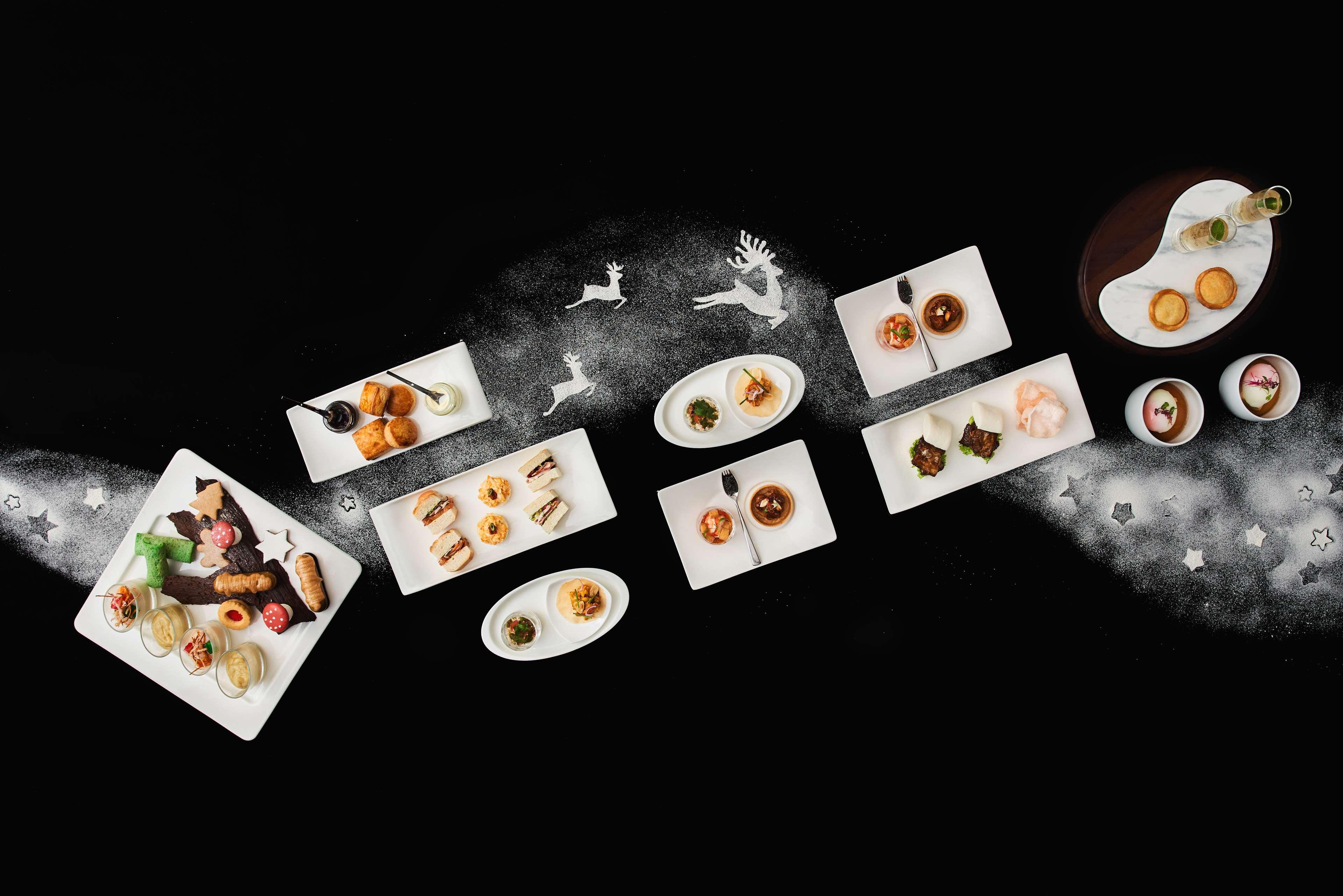 Paradox Singapore Merchant Court At Clarke Quay المظهر الخارجي الصورة The photo showcases an elegant arrangement of various dishes presented on white plates, set against a dark background. The dishes include an assortment of culinary items, possibly desserts and appetizers, artistically plated and garnished. There are 