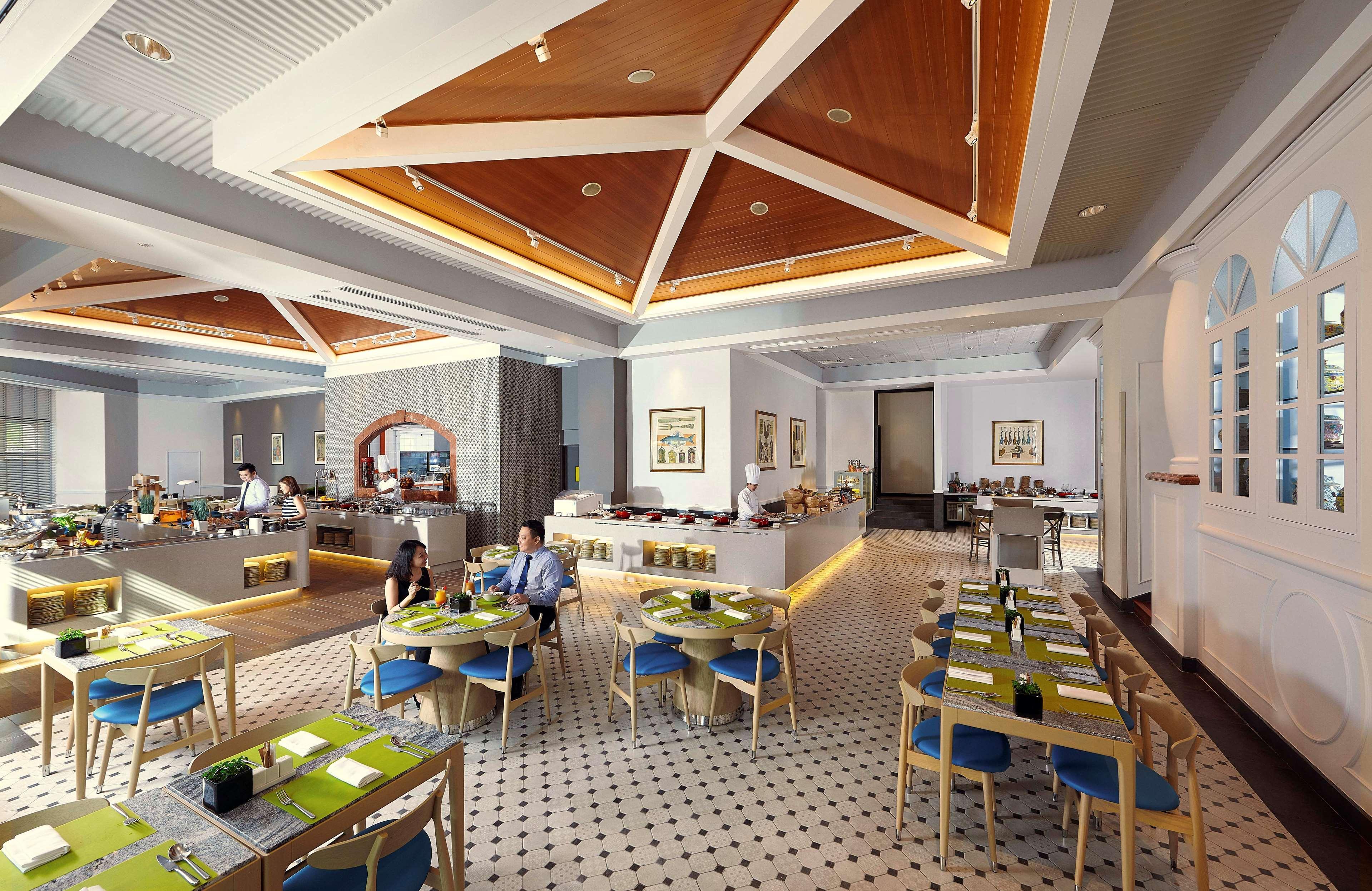 Paradox Singapore Merchant Court At Clarke Quay المظهر الخارجي الصورة The photo shows a modern restaurant interior with a spacious layout. The ceiling features a geometric wooden design, adding a touch of elegance. The floor has a checkered pattern, contributing to the decor's stylish feel. 

There are several tables a